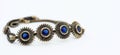 Bronze bracelet with blue crystals, white background