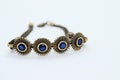 Bronze bracelet with blue crystals, white background