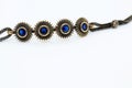 Bronze bracelet with blue crystals, white background