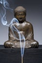 Bronze Buddha Statue With Burning Incense Smoke Royalty Free Stock Photo