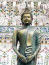 Bronze BUDDHA statue in front of decoration ornament details of famous historic buddhism stupa in WAT ARUN