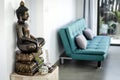 Bronze buddha statue interior design detail in modern asian home Royalty Free Stock Photo