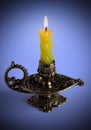 Bronze candlestick with burning candle Royalty Free Stock Photo