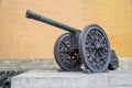 A bronze cannon on a carriage located on a white stone pedestal near the arsenal building in the Kremlin, Moscow Royalty Free Stock Photo