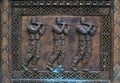 Bronze carving relief with three men figures in traditional Mace