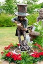 Bronze cast of the Mad Hatter pouring tea. Royalty Free Stock Photo