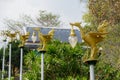 Bronze casting Thai literature swans carrying bell-shaped electricity lantern painted with gold colour