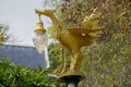 Bronze casting Thai literature swans carrying bell-shaped electricity lantern painted with gold colour