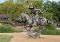 Bronze cowboy on horseback with steers in the background in the Pioneer Plaza, Dallas, Texas. Royalty Free Stock Photo