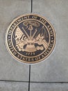 Bronze Department of the Army seal memorial on gray cement