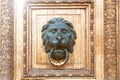 Bronze door handle in the shape of a lion`s head Royalty Free Stock Photo