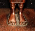 Bronze feet without shoes. Statuette element. Iron bare feet