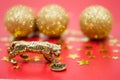 A bronze figure of a tiger with a coin - the symbol of the Chinese new year 2022 on a red background, gold stars and balls, a copy