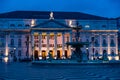 Bronze fountain and illuminated facade of National Theatre at Rossia Square in Lisbon