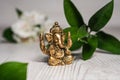 Bronze Ganapathi Ganesha Idol decorated with white flowers and green leaf in background