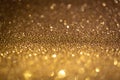 Bronze glitter lights. Shiny sparkles, bokeh effects, glowing surface. Selective focus, christmas abstract background Royalty Free Stock Photo