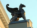 Bronze griffin statue at sunset
