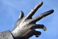 Bronze hand reaching outward