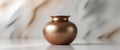 Bronze jar sits on a glossy surface with a blurred abstract backdrop. Royalty Free Stock Photo