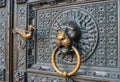 Bronze knocker in the shape of a lion`s head at the gate of the Cologne Cathedral, the most famous church in Germany. Royalty Free Stock Photo