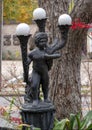 Bronze lamp featuring a young boy inside Dragon Park in the Oak Lawn neighborhood in Dallas, Texas.