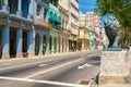 Bronze lion and colorful buildings at Paseo del Prado in Havana