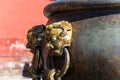 Bronze lion handles on the bronze water tank in side of the Forbidden city, the main buildings of the former royal palace of Ming