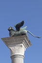 Bronze lion on the Piazza San Marco on blue sky background, Venice, Italy. Winged lion is a symbol of Venice. Ancient statue on a Royalty Free Stock Photo