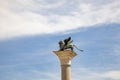 Bronze lion on the Piazza San Marco on blue sky background, Venice, Italy. Winged lion is a symbol of Venice. Ancient statue on a Royalty Free Stock Photo