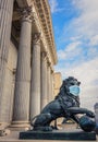 Bronze lion statue in front of the Spanish Parliament with a surgical mask