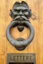Bronze male head door knob on the door in Italy Royalty Free Stock Photo
