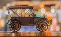 Bronze model toy retro car stands on a wooden surface on an abstract background Royalty Free Stock Photo