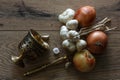 Bronze morter and group of garlics and onions