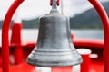 Bronze old bell on red holder in a boat - Close up Royalty Free Stock Photo