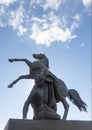 Bronze sculpture of athlete taming horse  at an Anichkov bridge in St. Petersburg against the blue sky Royalty Free Stock Photo