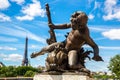 Bronze sculpture on the Bridge Pont Alexandre III and Eiffel Tower in the behind in Paris, France Royalty Free Stock Photo