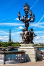 Bronze sculpture on the Bridge Pont Alexandre III and Eiffel Tower in the behind in Paris, France Royalty Free Stock Photo