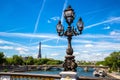 Bronze sculpture on the Bridge Pont Alexandre III and Eiffel Tower in the behind in Paris, France Royalty Free Stock Photo