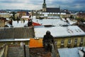 Bronze sculpture of the Chimney sweep on the roof of a house in Lviv