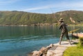 A bronze sculpture depicting a knife a fisherman on the lakefront in Bissone, Switzerland