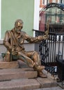 Bronze sculpture of an elderly man in the historical center of Omsk in summer
