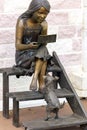 bronze sculpture of a girl lying on a bench reading a book in the P.P. Bazhova on a summer day