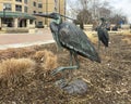 Bronze sculpture of a heron with McGloin Hall in the background on the campus of Creighton University in Omaha, Nebraska.