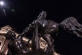 Bronze sculpture of Horse tamer at night time
