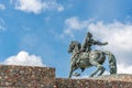 Bronze sculpture of a horseman on a horse on a stone pedestal Royalty Free Stock Photo