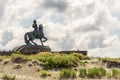 Bronze sculpture of a horseman on a horse on a stone pedestal Royalty Free Stock Photo