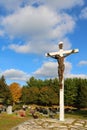 Bronze sculpture of Jesus Christ on white wooden cross at cemetery Royalty Free Stock Photo