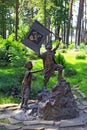 Bronze sculpture of little boy with flag and girl going up mountain in city park