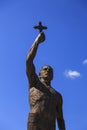 Bronze sculpture of a man holding a cross sign in Ohrid town, Ma