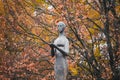 Bronze sculpture of mournful woman holding burning candle